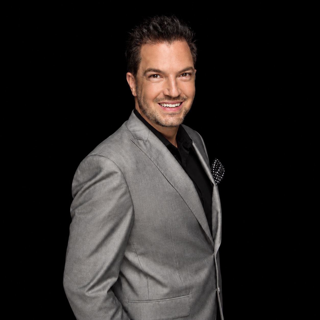 Terry Tripp in a gray jacket against a black background