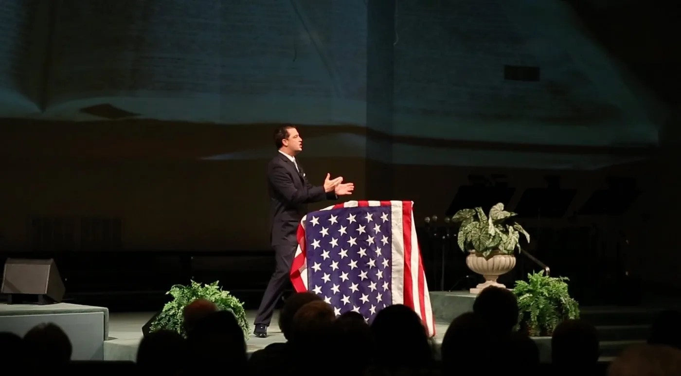 Terry Tripp speaking at a Christian ministry event.